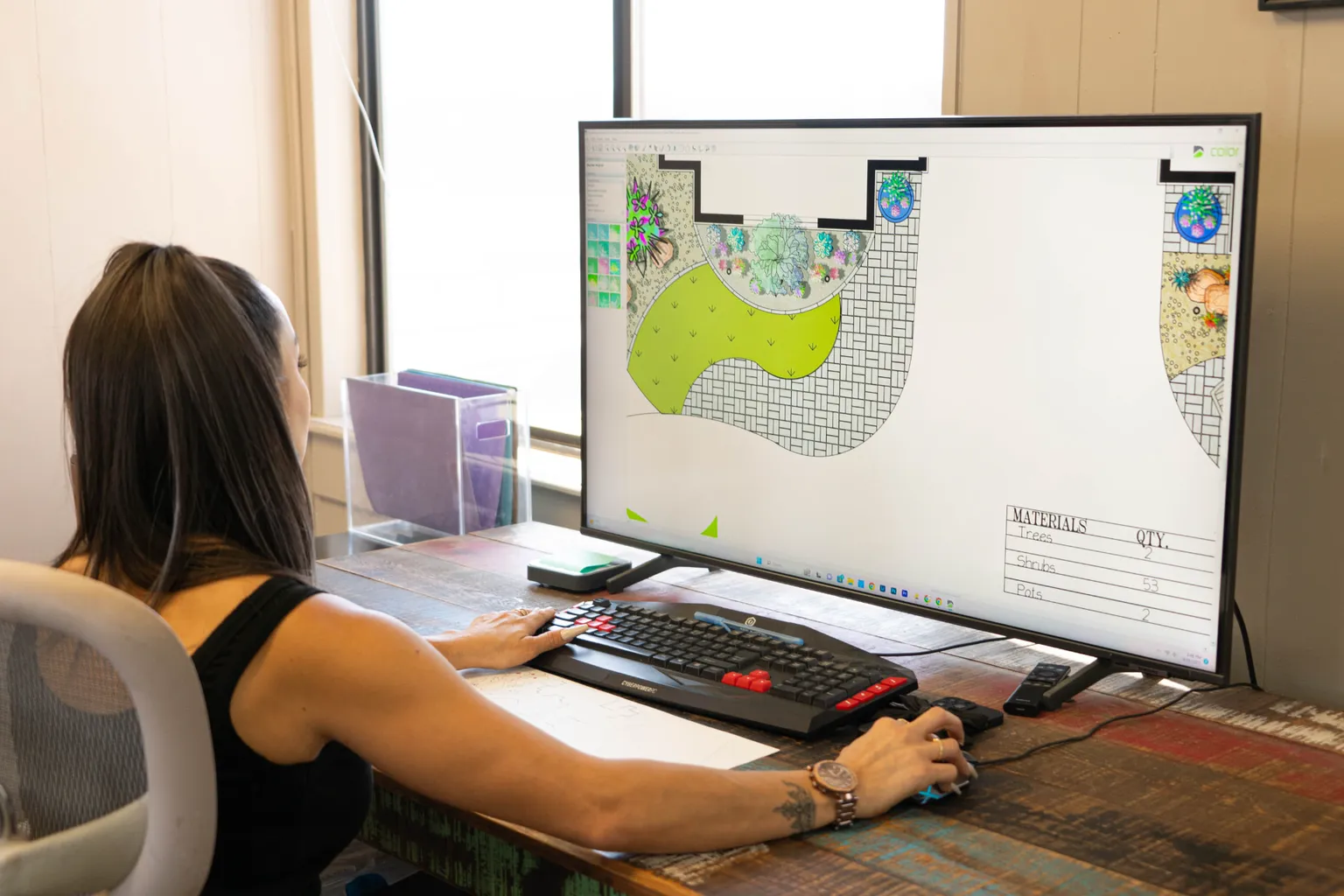Garden Center of Las Cruces designer building a landscape plan in design software on a large monitor in the Las Cruces, NM office Garden Center of Las Cruces designer building a landscape plan in design software on a large monitor in the Las Cruces, NM office