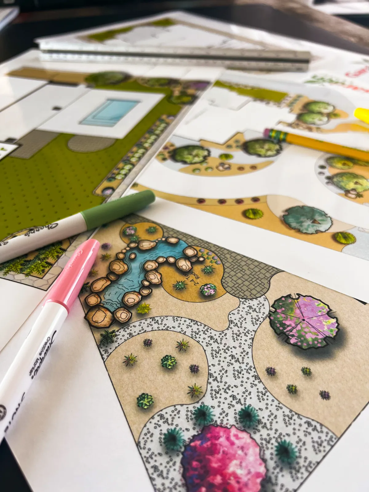Hand-drawn color landscape plans for a Las Cruces, NM backyard with a pool, lawn, walkways, and rock beds